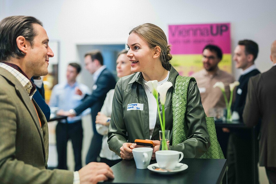 A man and a woman talking over a cup of coffee