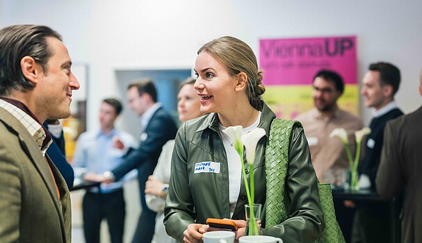 A man and a woman talking over a cup of coffee