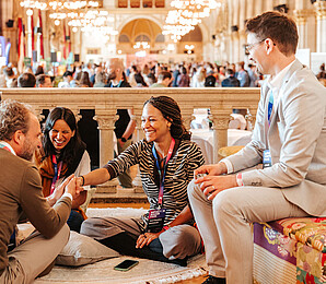 Four people talking in the Vienna City Hall on the first day of the Impact Days 2026